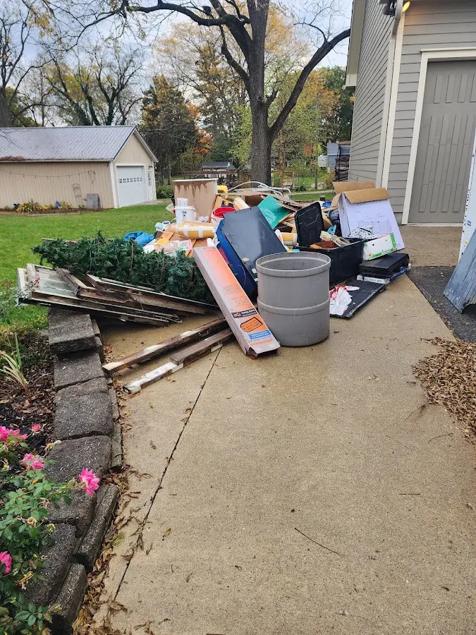 Dumpster being loaded with debris for Roofing Dumpster Rental in Neosho